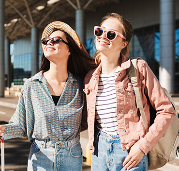 Girls are ready to travel, taking a picture at the airport.