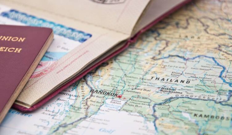 Close up image of Thailand passport with a map along its side.