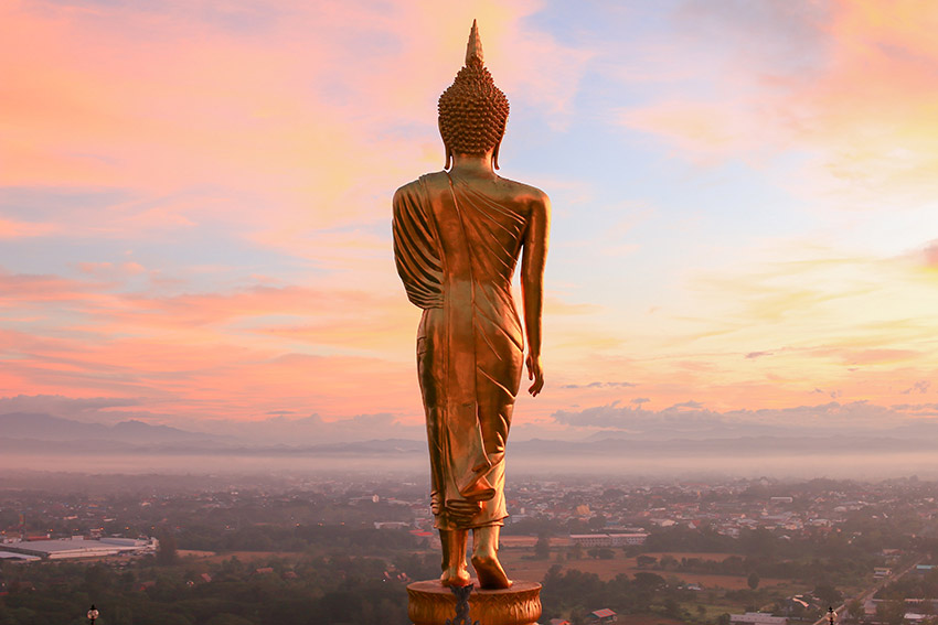 Standing Buddha statue in Thailand viewed from behind